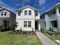 Charming two-story home featuring a neatly landscaped yard and a welcoming front entrance at 15173 Summer Harvest St, Winter Garden, FL 34787