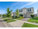 Beautiful two-story home with blue shutters, a well-kept lawn, and a paved driveway at 1551 Flange Dr, Davenport, FL 33896