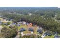 View of single Gathering home surrounded by green trees and other homes in a residential neighborhood at 17236 Sw 44Th Cir, Ocala, FL 34473
