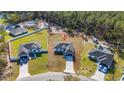Aerial view of a single Gathering home in a quiet neighborhood surrounded by lush green trees at 17236 Sw 44Th Cir, Ocala, FL 34473