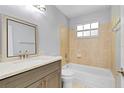 Cozy bathroom features a tub and shower combination with updated fixtures and a classic vanity at 2007 Royal Bay Blvd # 144, Kissimmee, FL 34746