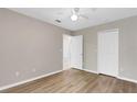 Neutral bedroom featuring wood-look floors, a ceiling fan, and a closet for ample storage at 2007 Royal Bay Blvd # 144, Kissimmee, FL 34746