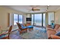 Bright living room featuring stylish furniture and direct access to a private balcony with ocean views at 2401 S Atlantic Ave # D306, New Smyrna Beach, FL 32169