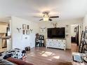 Spacious living area with luxury vinyl flooring, ceiling fan, and seamless connection to the dining area and backyard at 278 Silverstone Dr, Orange City, FL 32763