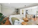 Inviting living room featuring hardwood floors, neutral paint, and views into dining area at 2827 Upper Park Road, Orlando, FL 32814