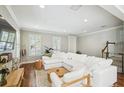 Bright living room with hardwood floors, neutral paint, white trim, and cozy, white sectional sofa at 2827 Upper Park Road, Orlando, FL 32814