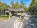 Stone gatehouse welcomes residents to a private community surrounded by lush trees, shrubbery and landscaping at 2861 Black Birch Dr, Ocoee, FL 34761