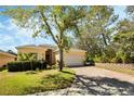 Inviting single-story home featuring a brick driveway, two-car garage, and lush green landscaping at 2933 Star Grass Pt, Oviedo, FL 32766