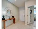 Bright foyer featuring tile floors, an accent wall, and stylish decor at 33436 Seattle Slew Dr, Sorrento, FL 32776