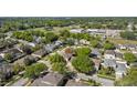 Aerial view of the home nestled among mature trees in a peaceful residential neighborhood at 3344 Quailwest Ct, Orlando, FL 32812