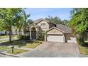 Charming two-story home with a three-car garage and a landscaped front yard at 3344 Quailwest Ct, Orlando, FL 32812