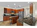 Well-equipped kitchen with stainless steel appliances, granite countertops, and custom cabinetry at 3344 Quailwest Ct, Orlando, FL 32812