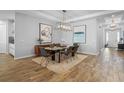 Elegant dining room with modern lighting, wood-look tile floors, stylish decor and modern accents at 3375 Hanging Tide St, Winter Garden, FL 34787