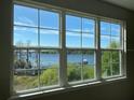 Bright lake view from a window in a condo with a view of a dock, gazebo and lush scenery at 3384 Corona Village Way # 202, Orlando, FL 32835