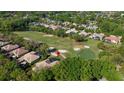 Residential homes bordering a lush green golf course surrounded by mature trees and a serene pond at 3400 Park Grove Ct, Longwood, FL 32779