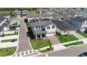 Aerial view of a two-story home with a manicured lawn and view of the neighborhood at 4911 Shady Pines Dr, St Cloud, FL 34772