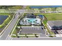 An aerial view of a community pool featuring palm trees, ample seating, and a playground at 4911 Shady Pines Dr, St Cloud, FL 34772