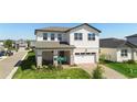 Two-story home with brick driveway and lawn at 4911 Shady Pines Dr, St Cloud, FL 34772