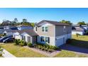Well-maintained two-story home with a landscaped front yard and private driveway in a residential neighborhood at 5251 Meredrew Ln, St Cloud, FL 34771