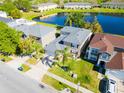 Aerial view of the home showcasing the well-manicured lawn, landscaping, and proximity to the lake at 543 Flower Fields Ln, Orlando, FL 32824