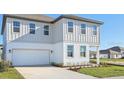 Inviting two-story home boasting a two-car garage and lush landscaping at 5717 Haystack Dr, St Cloud, FL 34771