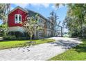 Striking exterior of a modern home with a colorful facade, stone accents, and a paved driveway at 5824 N Dean Rd, Orlando, FL 32817