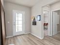 Light-filled foyer with wood-look floors, adjacent to dining area at 7006 Rosy Sky Ave, Orlando, FL 32829