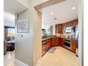 Modern kitchen featuring stainless steel appliances, warm-toned cabinets and granite countertops at 7593 Gathering Dr # 203, Reunion, FL 34747