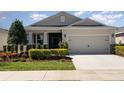 Lovely single-Gathering home with a tidy yard and neutral color palette, creating a welcoming curb appeal at 7838 Penrose Pl, Wildwood, FL 34785