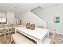Bright dining area with white table, bench seating, and stylish decor at 8199 Coconut Pl, Kissimmee, FL 34747