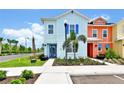 Inviting two-story home featuring a cheerful light blue exterior and lush landscaping at 8199 Coconut Pl, Kissimmee, FL 34747