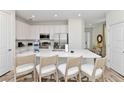 Modern kitchen with white cabinetry, stainless steel appliances, and spacious island at 8199 Coconut Pl, Kissimmee, FL 34747