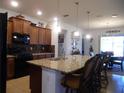 Bright kitchen boasting a large island, pendant lighting, and ample cabinet space for storage and style at 8824 Sw 104Th Cir, Ocala, FL 34481