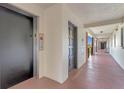 Building hallway featuring an elevator, unit doors, and an open breezeway with sunny exterior views at 100 S Interlachen Ave # 503, Winter Park, FL 32789