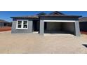 Exterior view of a single-story home, partially built with an attached garage, showcasing its modern design at 1013 Alabaster Way, Deltona, FL 32725