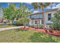 Beautiful exterior shot of home with charming landscaping and blue siding on a sunny day at 122 Spreading Oak Ct, Sanford, FL 32773