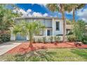 Charming two-story home with palm trees and well-maintained landscaping in a sunny, bright shot at 122 Spreading Oak Ct, Sanford, FL 32773