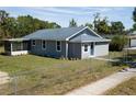 Stylish home boasting light gray siding, complemented by a screened-in porch, and a well-maintained lawn at 1350 Martin Luther King Jr Blvd, Bartow, FL 33830