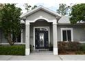 Inviting front entry with decorative glass door, sidelights and manicured shrubbery at 14641 Henson Rd, Orlando, FL 32832