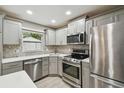 Modern kitchen featuring stainless steel appliances, granite countertops, and ample cabinet space at 1514 Pelican St, Longwood, FL 32750