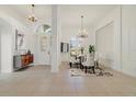 Bright, open dining room featuring a chandelier and elegant furniture near the front entryway at 1521 Gants Cir, Kissimmee, FL 34744