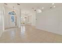 Spacious living room featuring tile floors, large windows, and stylish chandeliers creating an inviting atmosphere at 1521 Gants Cir, Kissimmee, FL 34744