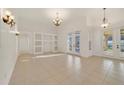Bright and airy living area featuring built-in shelving, tile flooring, and access to the outdoor space at 1521 Gants Cir, Kissimmee, FL 34744