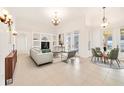 Bright living room featuring a neutral palette, built-in shelving, and a dining area with access to the outdoors at 1521 Gants Cir, Kissimmee, FL 34744