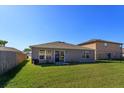 Exterior of the home showing a large yard and sliding glass doors at 15279 Sugargrove Way, Orlando, FL 32828