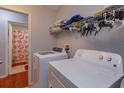 Laundry room with washer, dryer, and open shelving for storage at 15279 Sugargrove Way, Orlando, FL 32828