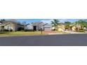 Charming gray home with a brick driveway, well-maintained landscaping, and a welcoming front entrance at 1530 Lexington Av Ave, Davenport, FL 33837