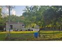 Exterior of the home, featuring a spacious yard and a mature shade tree at 18168 Cedarhurst Rd, Orlando, FL 32820