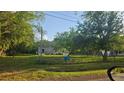 Home exterior with a fenced yard and mature trees, offering a sense of privacy at 18168 Cedarhurst Rd, Orlando, FL 32820