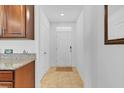 Bright hallway featuring tile flooring leading to the front door at 1932 Red Canyon Dr, Kissimmee, FL 34744